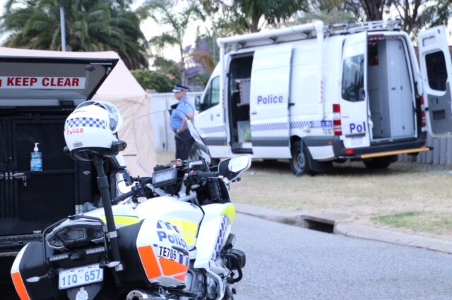 A WA Police motorbike and van sit parked on a road in the Perth suburb of Beechboro amid a crime scene.