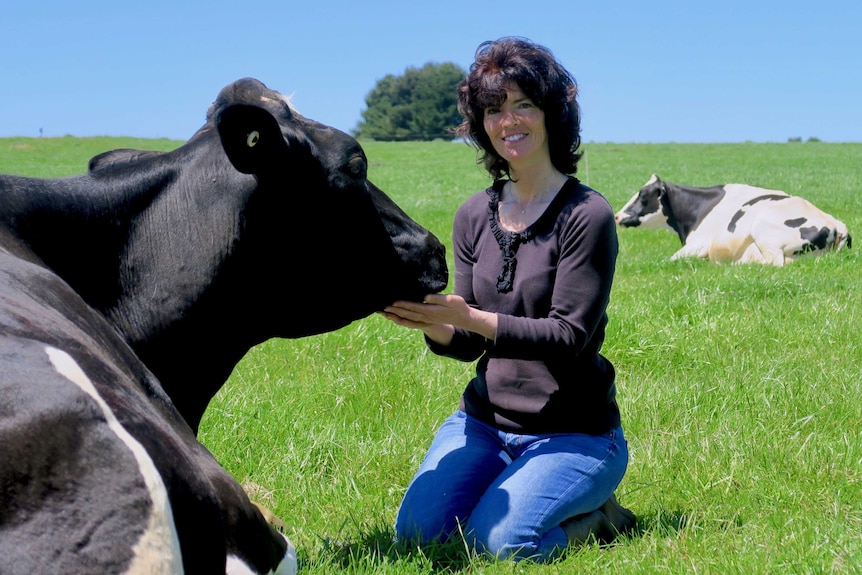 Leanne Dobson pets her favourite cow Tara at their property