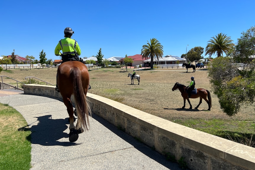 Mounted police search a park in a suburban part of Perth.