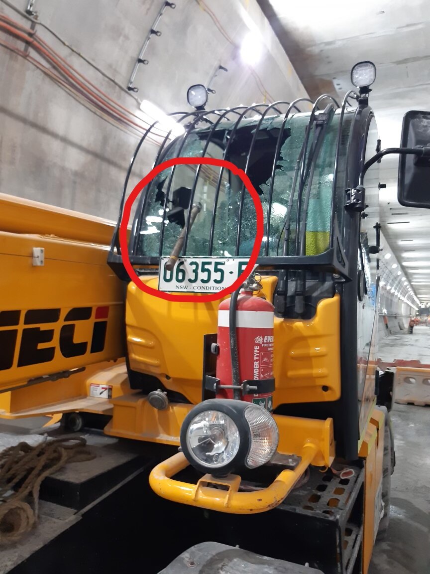 A steel rod protrudes from the smashed windscreen of a fork lift.