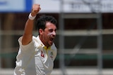 Australia bowler Mitchell Starc shouts and raises a hand in the air as he celebrates a wicket against Pakistan.