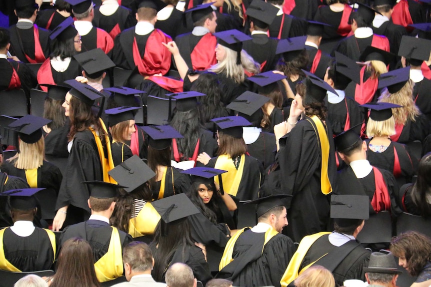 View of students from above as they wait at their graduation ceremony