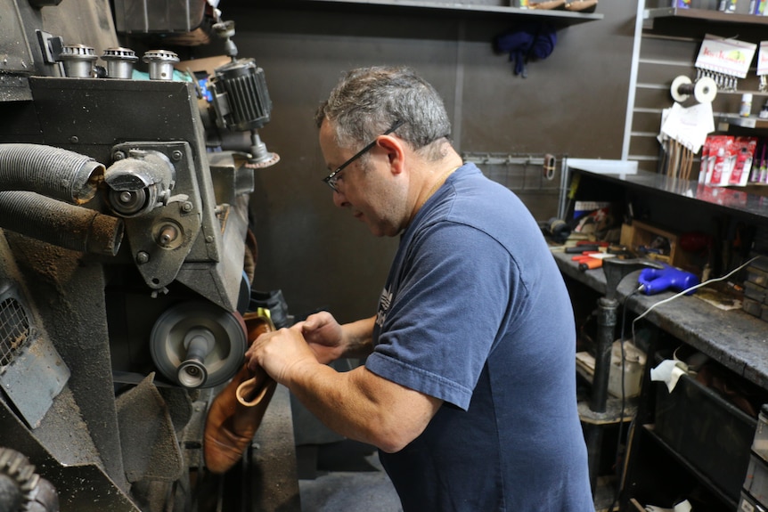 Sam Fazio repairs a shoe