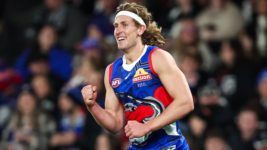 A Western Bulldogs AFL player pumps his right fist during a 2023 match.