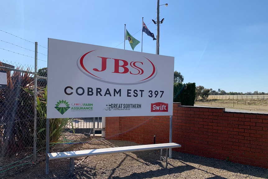 A business sign for JBS Cobram outside on a sunny day.