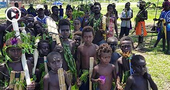 A group of children in the foreground at a reconciliation ceremony in Bougainville.