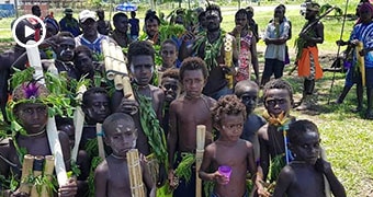 A group of children in the foreground at a reconciliation ceremony in Bougainville.