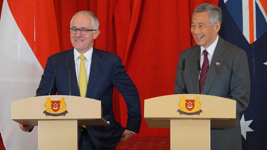 Malcolm Turnbull speaks in Singapore next to the country's Prime Minister.