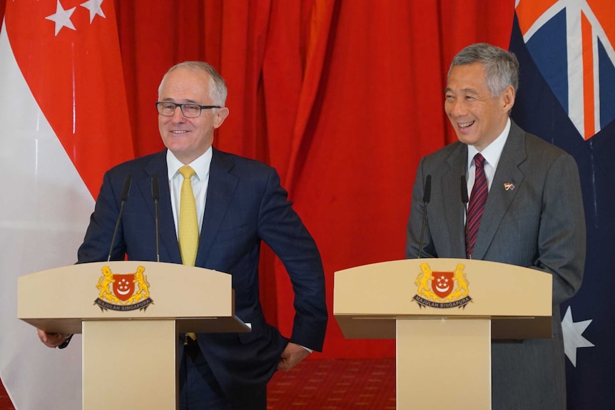 Malcolm Turnbull speaks in Singapore next to the country's Prime Minister.