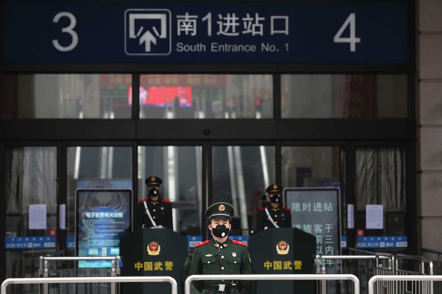 Chinese paramilitary police stand guard outside the closed Hankou Railway Station in Wuhan.
