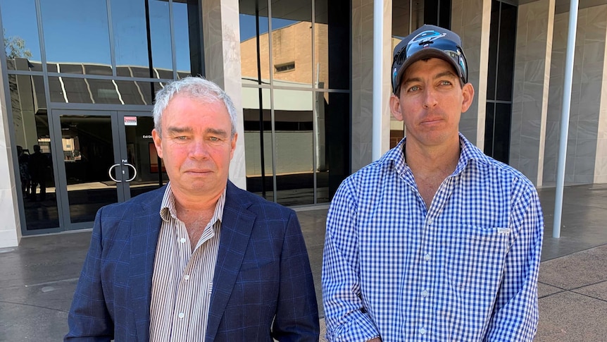 Alice Springs Helicopters managing director Warwick Curr and director and chief pilot James Griffiths stand outside court.