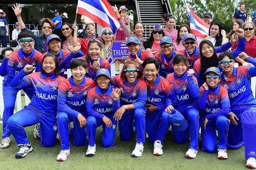 The Thailand women's cricket team smile as they post for a group photo.