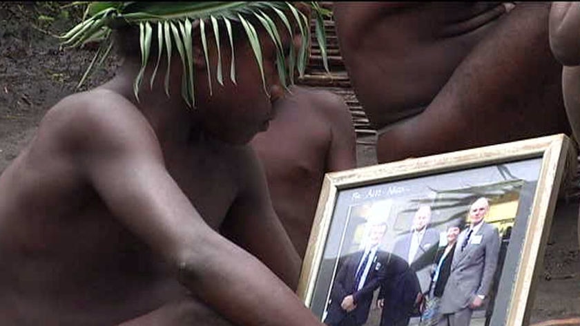 TV still of unidentifiable Tanna boy looking at photo of Prince Philip