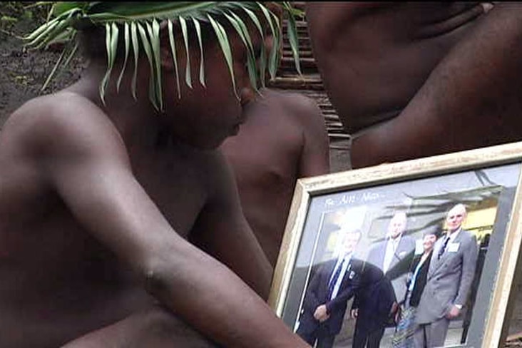 TV still of unidentifiable Tanna boy looking at photo of Prince Philip
