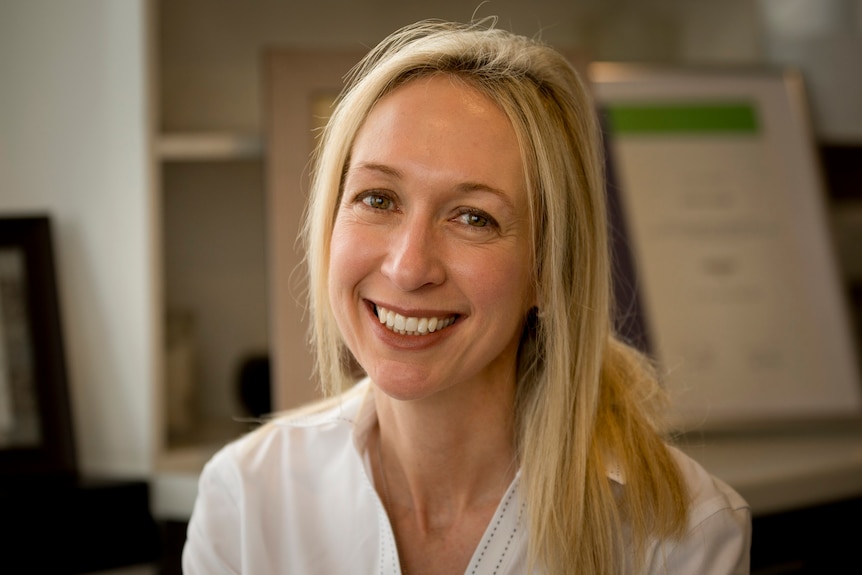 Jodie Lowinger looks at the camera in her office in Sydney.