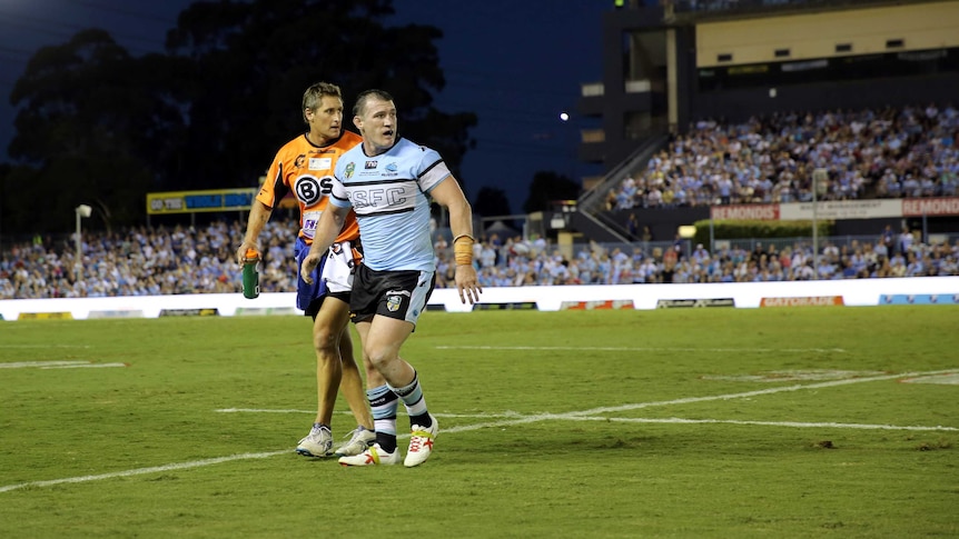 Cronulla captain Paul Gallen comes off the field injured during the NRL match against Gold Coast.