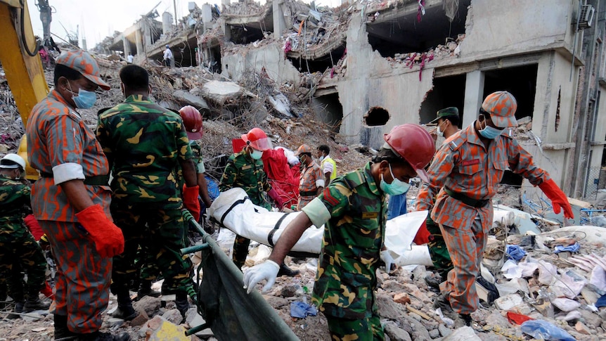 Rescue workers retrieve another body from the Rana Plaza building. More than 1100 people died when it collapsed in late April.