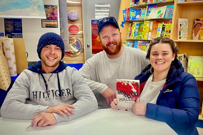 Author with two people buying his signed true crime book