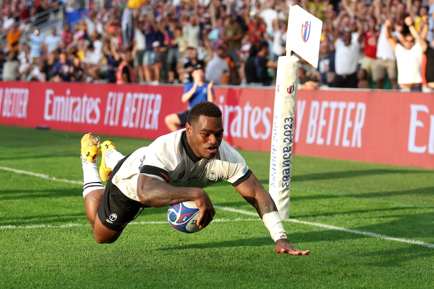 Josua Tuisova dives holding a ball