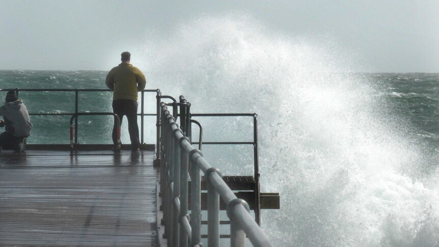A wave breaks in front of the Port Noarlunga jetty.