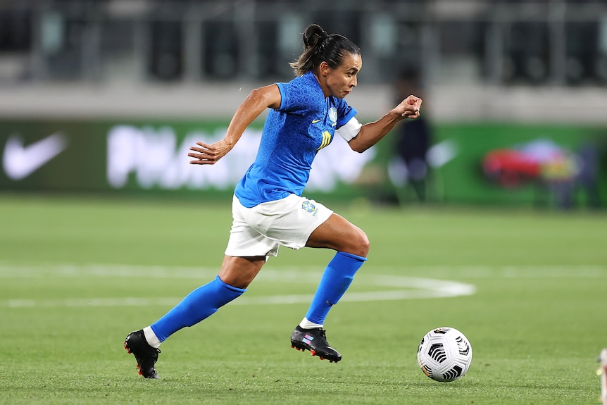 Marta runs with the ball at her feet