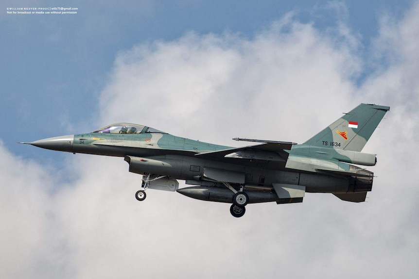 A photo of an Indonesian fighter jet with a backdrop of cloud.