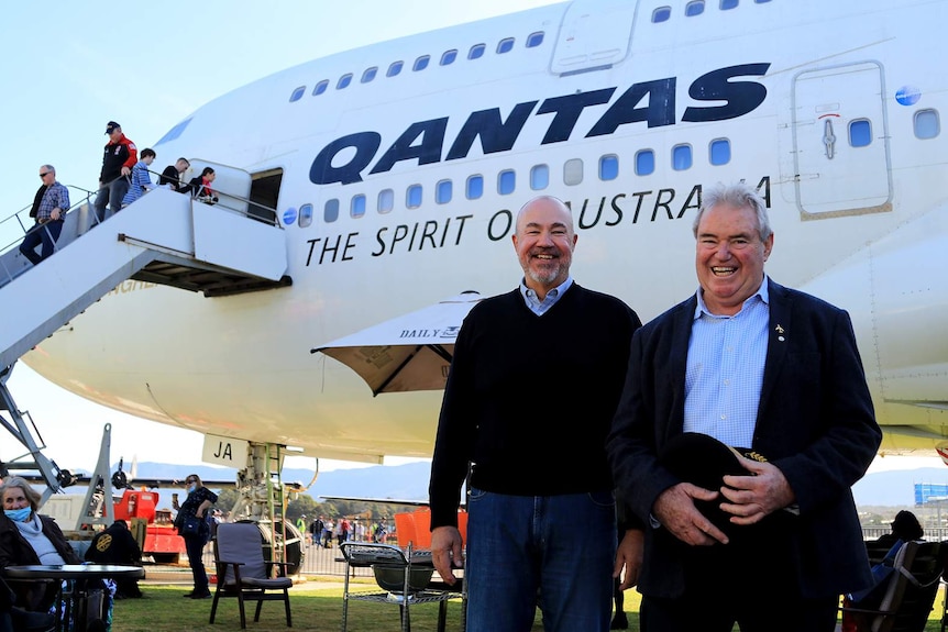 Greg Matthews and Ossie Miller stand in front of the Qantas 747 aircraft at HARS in Albion Park.