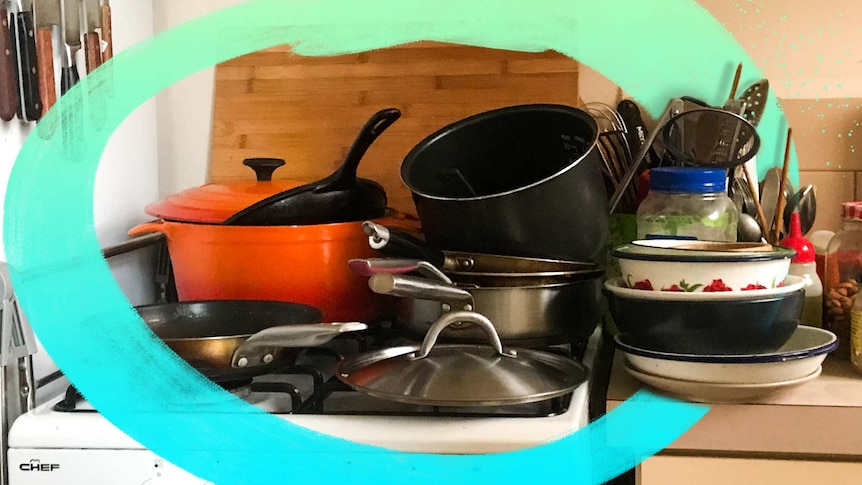 A pile of dirty pots, pans and bowls needing to be washed up, mess created by not meal planning.