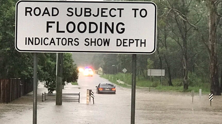 Car stranded in flood waters at Bellbird Park this morning in Ipswich.