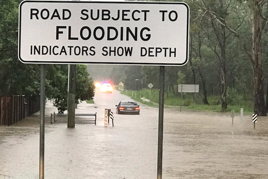 Car stranded in flood waters at Bellbird Park this morning in Ipswich.