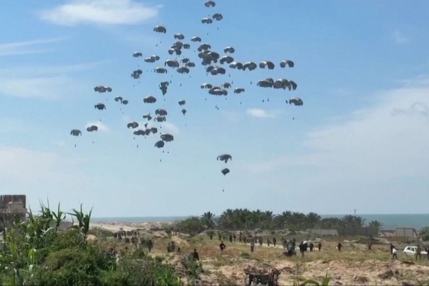 A flock of parachutes descend into Gaza.