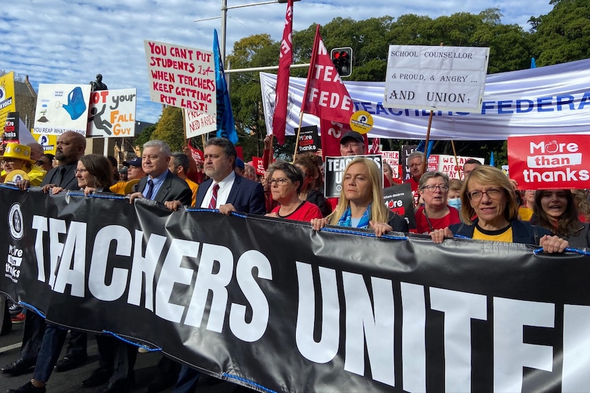 People holding a banner and walking