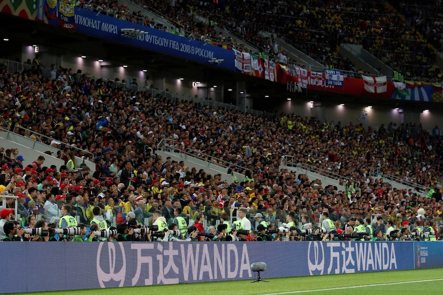 Football stadium with the brand Wanda plastered all over.