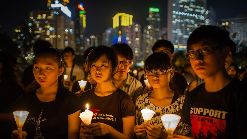 People take part in a a candlelight vigil in Hong Kong to mark the 1989 crackdown in Tiananmen Square.