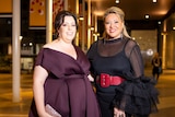 Karoline Dawe and Kylie Ward wearing nice evening dresses outside a gala event.
