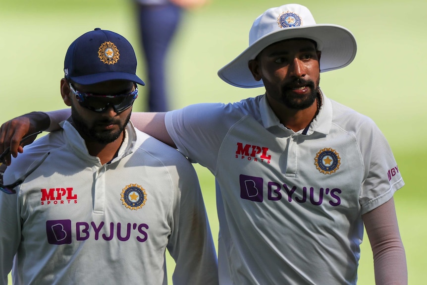 India players Rishabh Pant (left) and Mohammed Siraj leave the field after the first day of the Boxing Day Test.