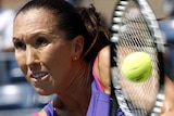 Jelena Jankovic hits a return during her three-set win