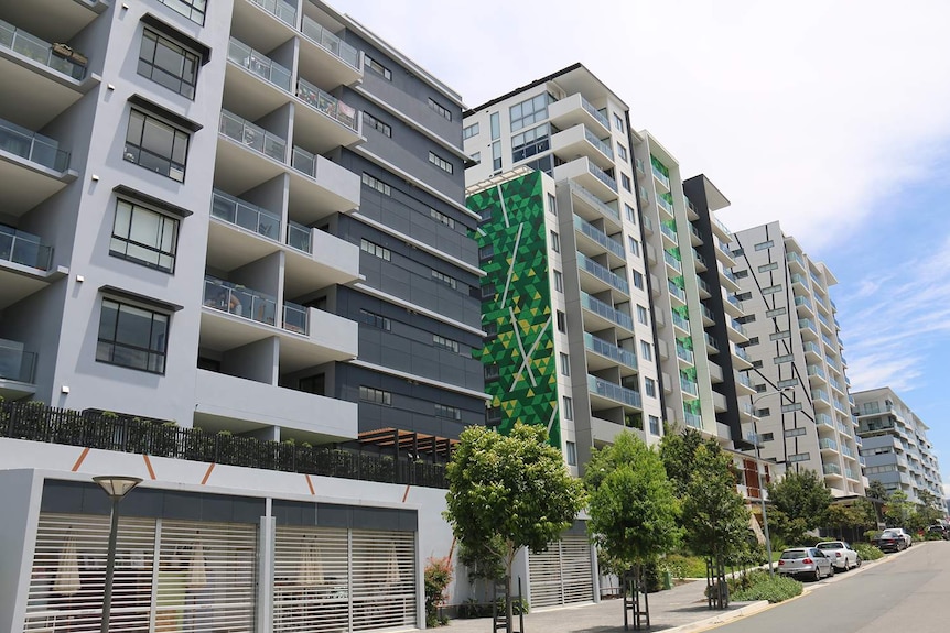 Apartment buildings along an uphill street in Brisbane.