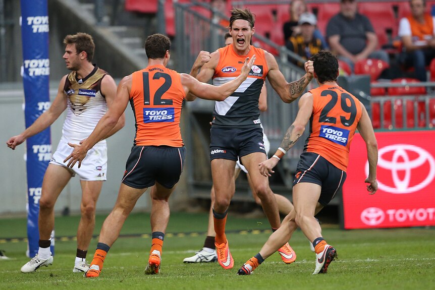 Giants' Rory Lobb and team-mates celebrates his goal against Hawthorn at Sydney Showgrounds.