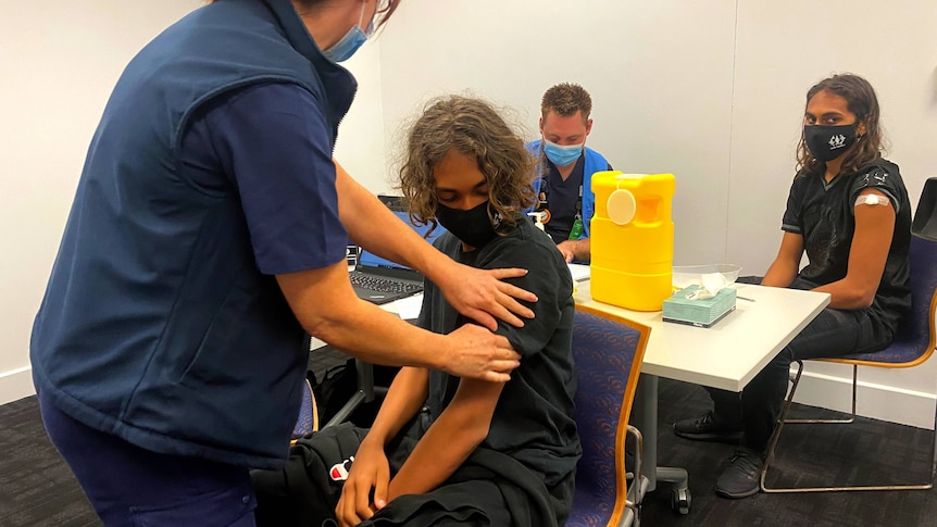 Indigenous children being vaccinated at an SA Health event at Mile End.