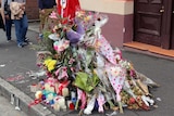 Roadside tribute to woman killed after a crash involving an allegedly stolen car.