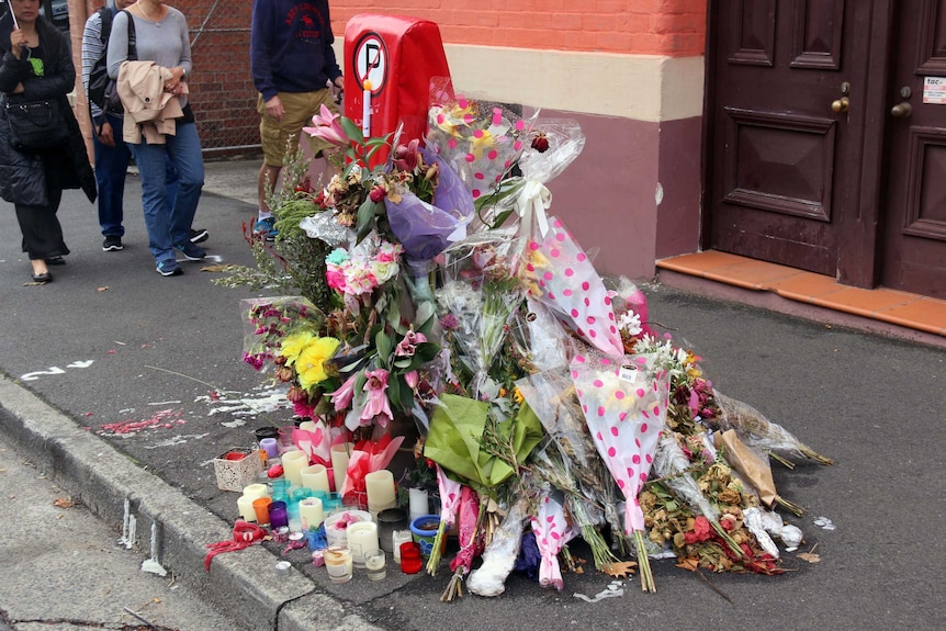 Flowers at a roadside tribute to a woman killed in a car crash.