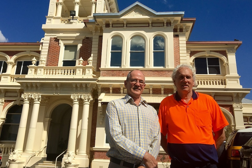 Two men, Michael Walker and Rob Jones, stand in front of the newly restored Kenmore House.