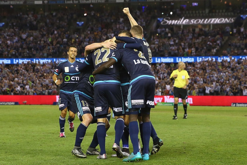 Vital result ... Melbourne Victory celebrate after an own goal by Matthew Jurman hands them the win