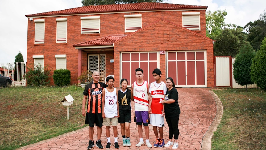 The Figueroa family standing outside their home.