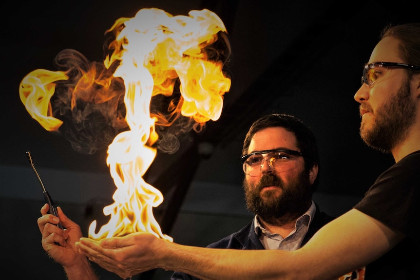 Nathan Kilah conducting an experiment with a flame burst.