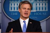 FBI Director Christopher Wray speaks during the daily press briefing