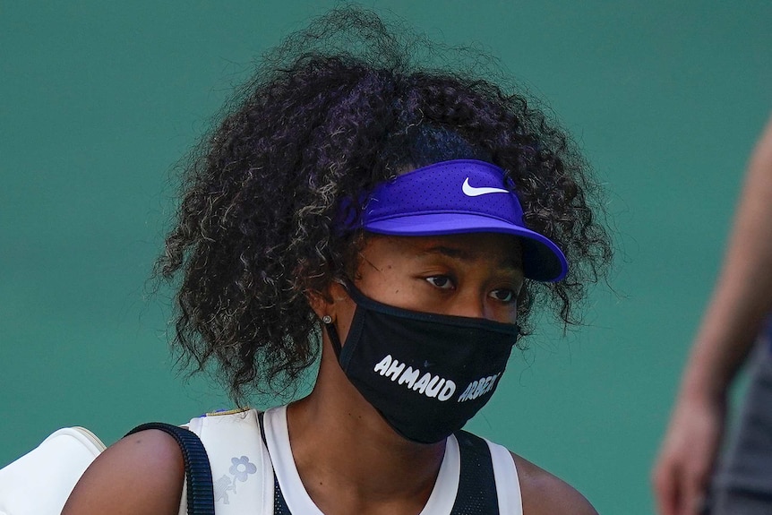Naomi Osaka wears a black mask with the name of Ahmaud Arbery written in white, capital letters