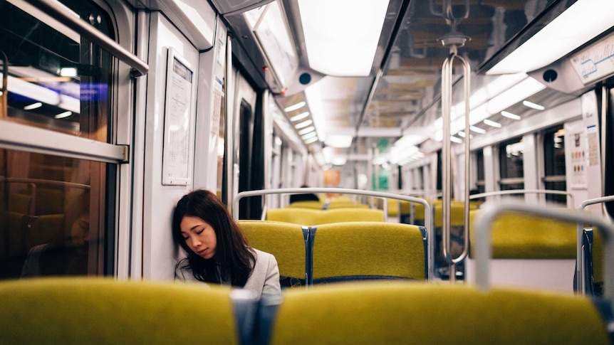 Young woman sleeping in train