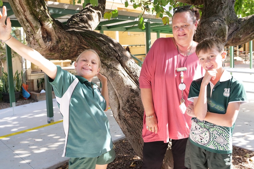 A woman with two school children.